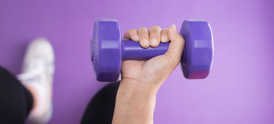 Woman lifting a dumbbell exercise in the gym 