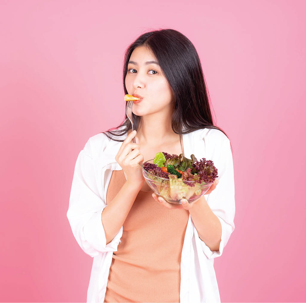 beauty woman Asian cute girl feel happy eating diet food fresh salad for good health on pink background - lifestyle beauty woman