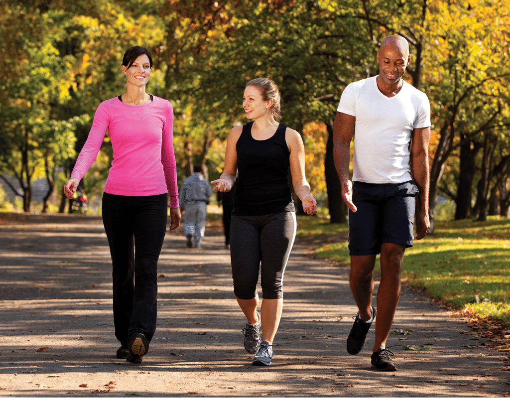 Three people walking in a park, getting some exercise