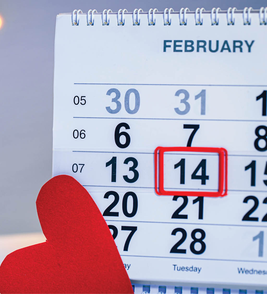 Calendar with the date February 14, a festive background with bokeh for Valentine's Day.