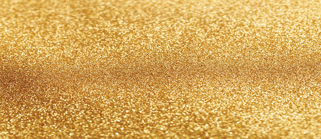 Abstract bokeh background with shining gold glitters.