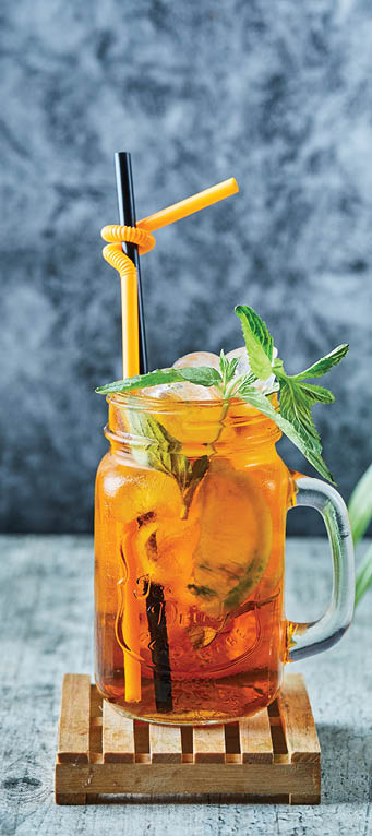 Juicy lemonade with straw and mint on the plant background . High quality photo