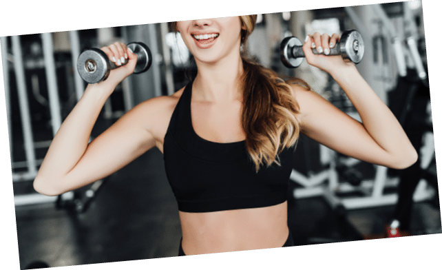 Portrait of an attractive sports girl with dumbbells in her hands, time for sports, workout, modern gym 