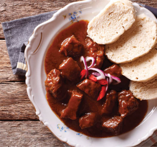 homemade hot Czech goulash with knodel in a plate close-up  horizontal view from above 