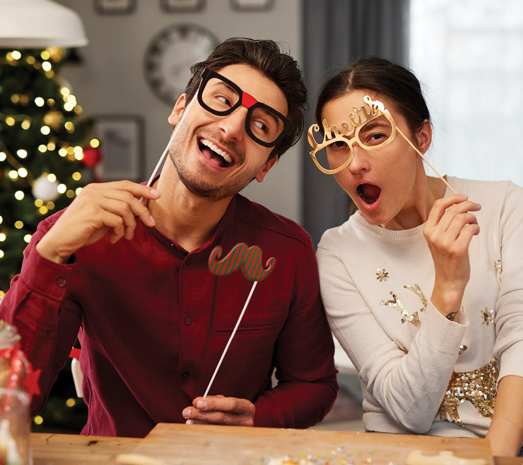 Portrait of playful couple in Christmas masks  