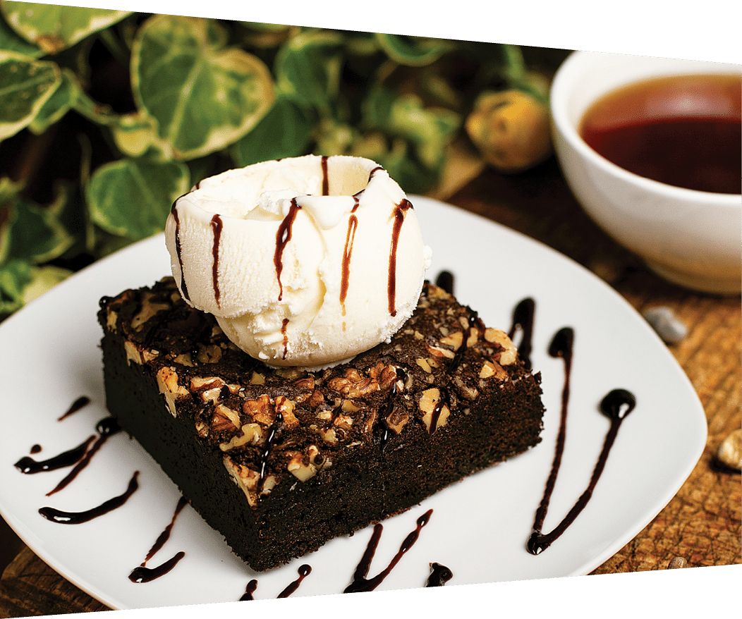A slice of chocolate brownie with walnut and vanilla ice cream  image