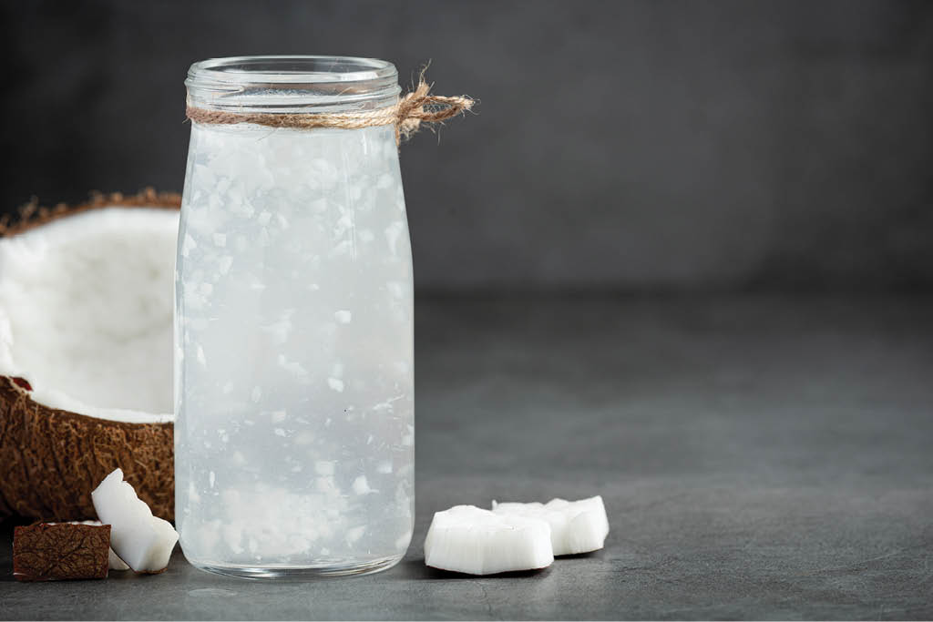 a bottle of coconut water put on dark background