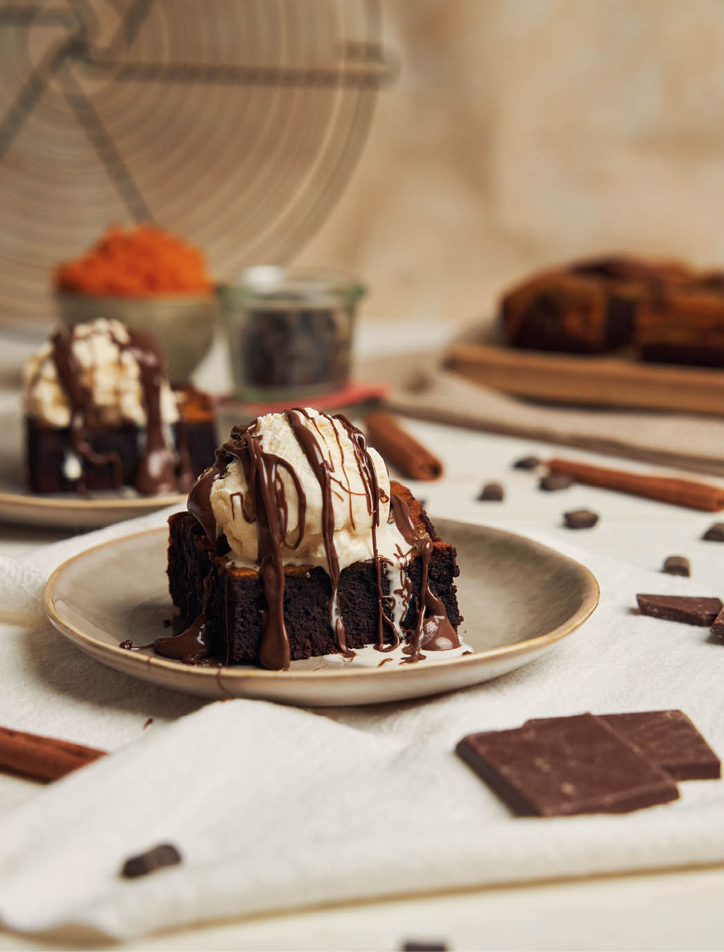 A closeup of a freshly baked delicious pumpkin chocolate brownie with ice cream on a plate