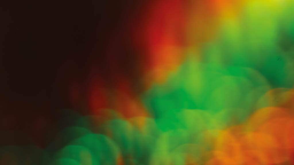 Green yellow red bokeh effect abstract background. Colored circles reggae rasta backdrop, jamaica pattern