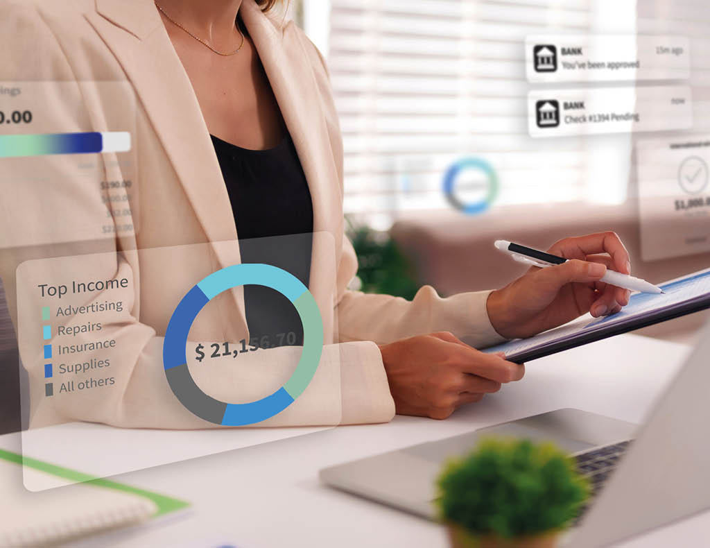 Professional woman reviews financial reports on clipboard with AR digital overlay showing income chart savings and bank alerts at office desk