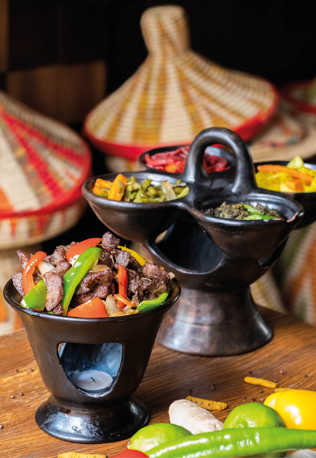 A vertical shot of delicious Ethiopian food with fresh vegetables on a wooden table