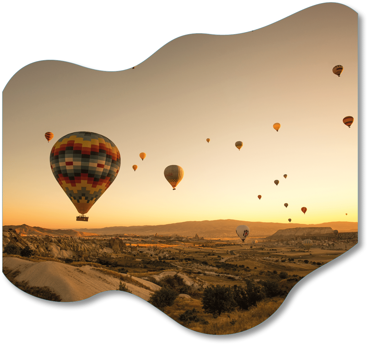 A set of colored balloons flying above the ground in Cappadocia, Turkey