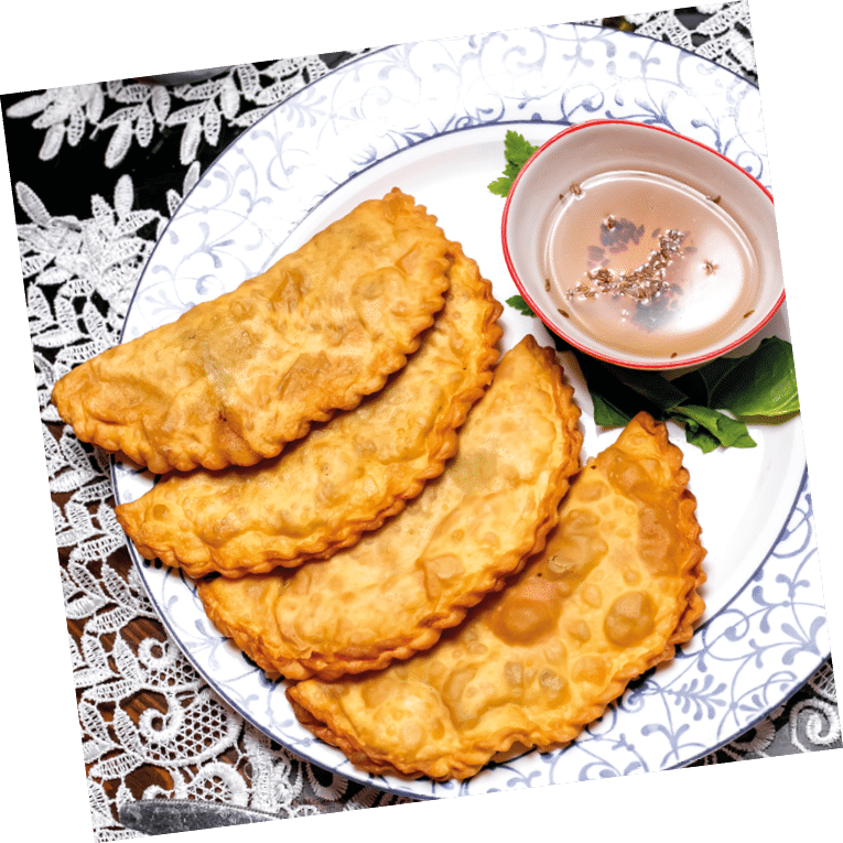 fried stuffed flatbread pastry served with sauce with sesame
