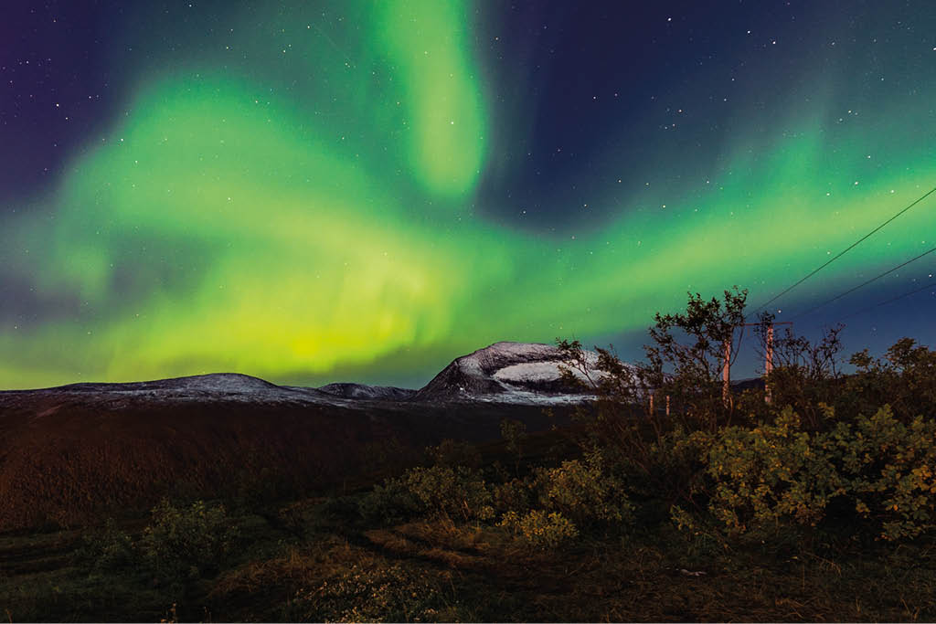 A beautiful scenery of aurora borealis in the night sky in Tromso Lofoten Islands, Norway